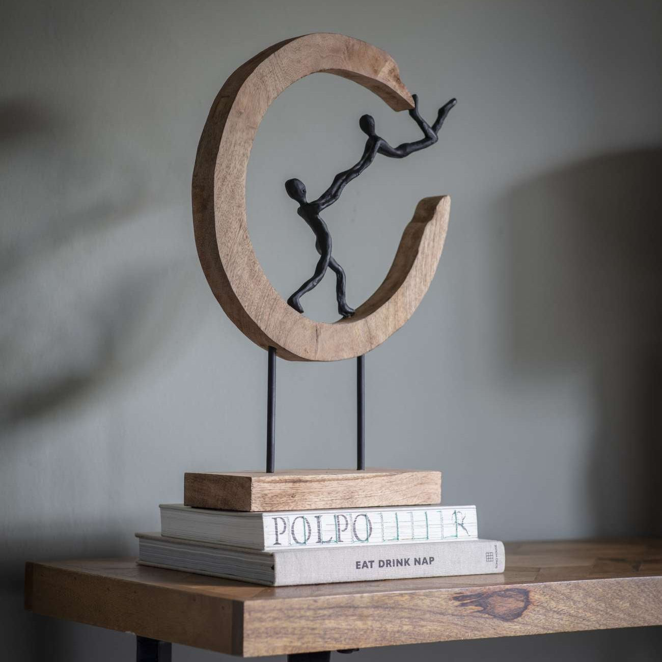 Playful People in Sculpture on Wooden Stand